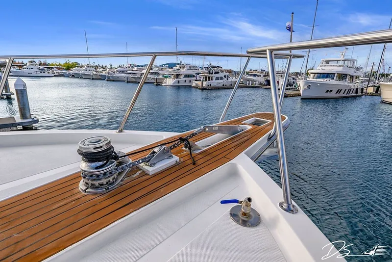Slide: The Image of 1993 Tollycraft 57 Pilothouse Motor Yacht docked in marina, showcasing deck and winch. - 36