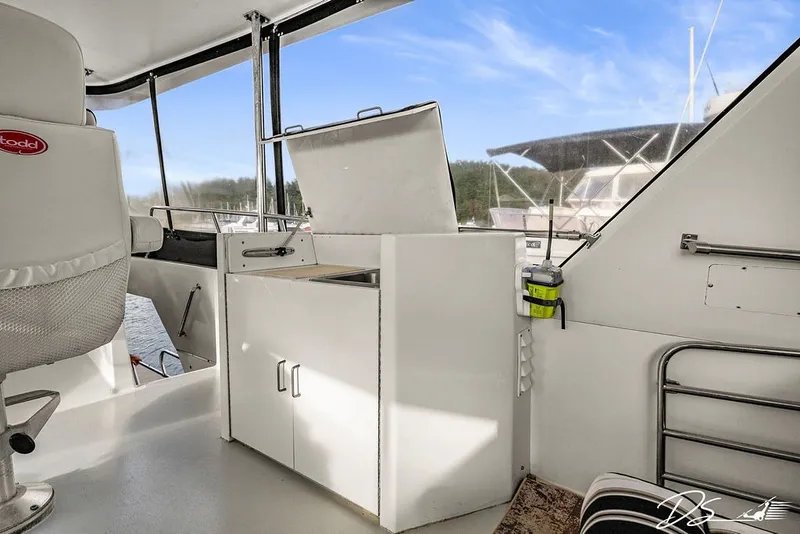 Slide: The Image of Interior view of 1993 Tollycraft 57 Pilothouse Motor Yacht, featuring helm and seating area. - 27
