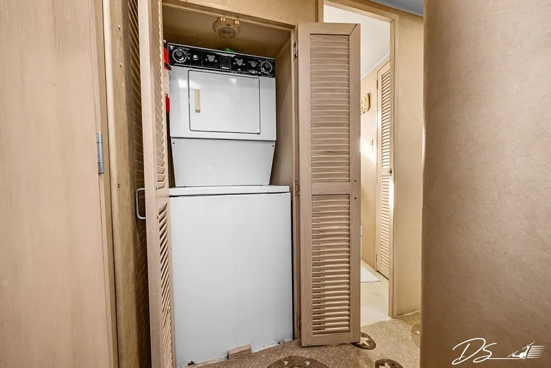 Slide: The Image of Laundry area with stacked washer and dryer in 1993 Tollycraft 57 Pilothouse Motor Yacht. - 21