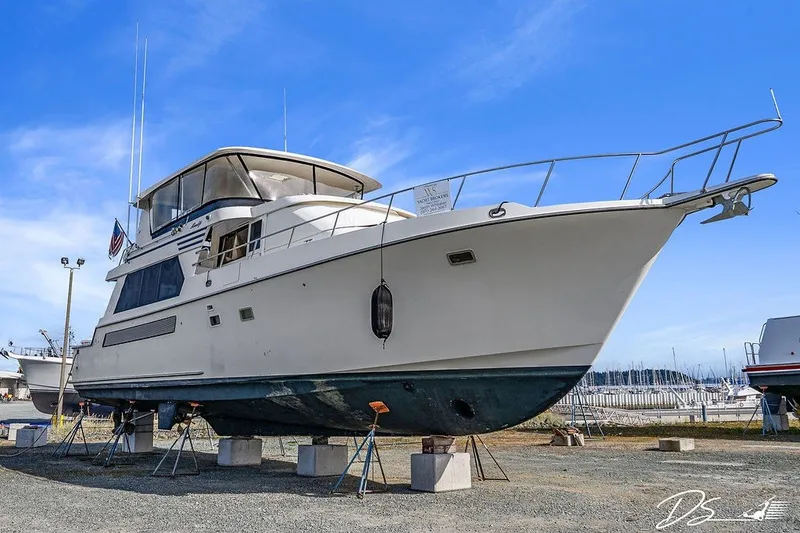 Slide: The Image of 1993 Tollycraft 57 Pilothouse Motor Yacht on dry dock under clear blue sky. - 55