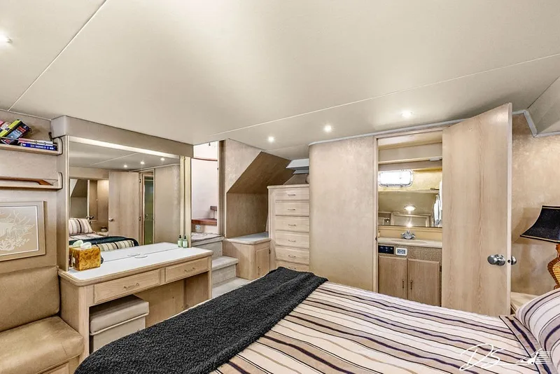 Slide: The Image of Luxurious bedroom interior of 1993 Tollycraft 57 Pilothouse Motor Yacht with elegant furnishings. - 13