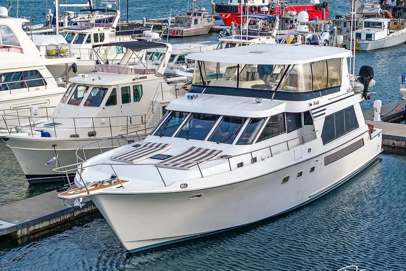 Slide: The Image of 1993 Tollycraft 57 Pilothouse Motor Yacht docked in a marina. - 50