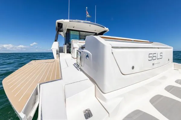 Slide: The Image of 2025 Tiara Yachts 56 LS luxury yacht on open sea, showcasing sleek design and spacious deck. - 18