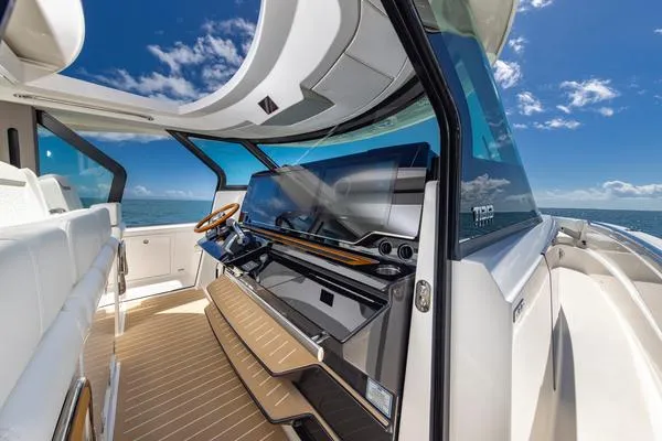 Slide: The Image of 2025 Tiara Yachts 56 LS interior with modern helm and ocean view. - 6