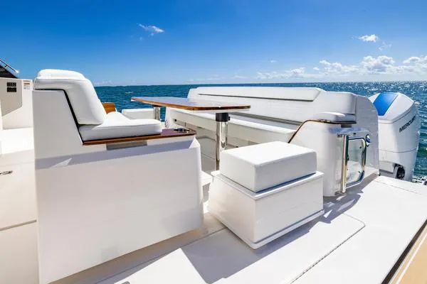 Slide: The Image of 2025 Tiara Yachts 56 LS luxury yacht deck with seating and ocean view. - 17
