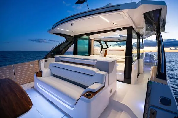 Slide: The Image of 2025 Tiara Yachts 56 LS luxury yacht interior at sunset, featuring sleek design and modern amenities. - 5