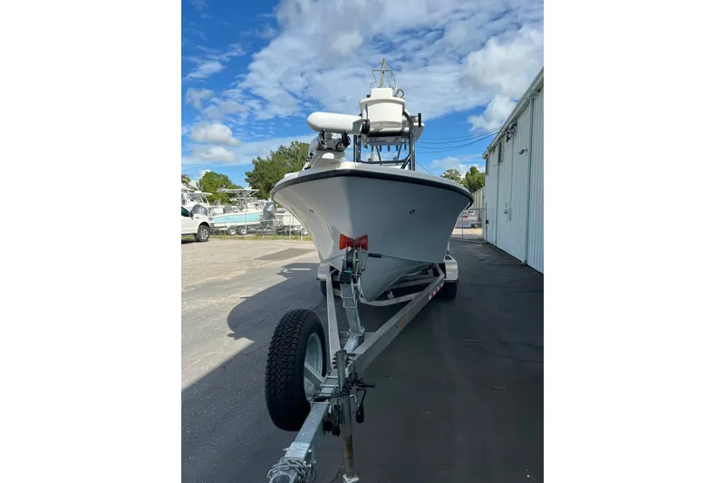 Slide: The Image of 2025 Delta Boatworks D245 on trailer, parked outdoors under a blue sky. - 25