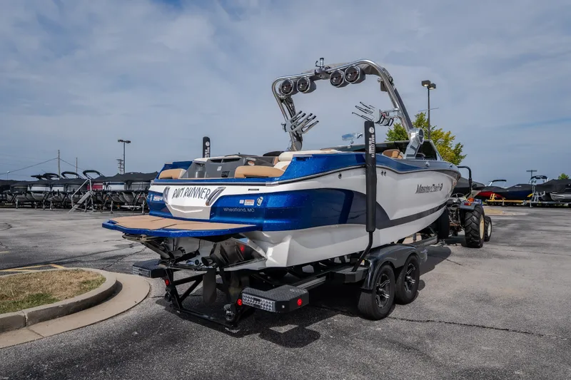Slide: The Image of 2021 MasterCraft X24 boat on trailer in parking lot, rear view. - 11