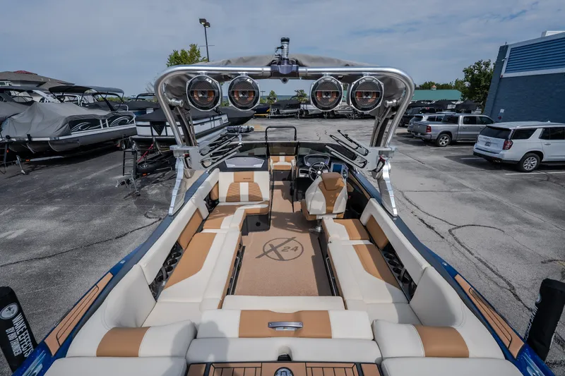 Slide: The Image of 2021 MasterCraft X24 boat interior with tan seating and advanced audio system. - 18