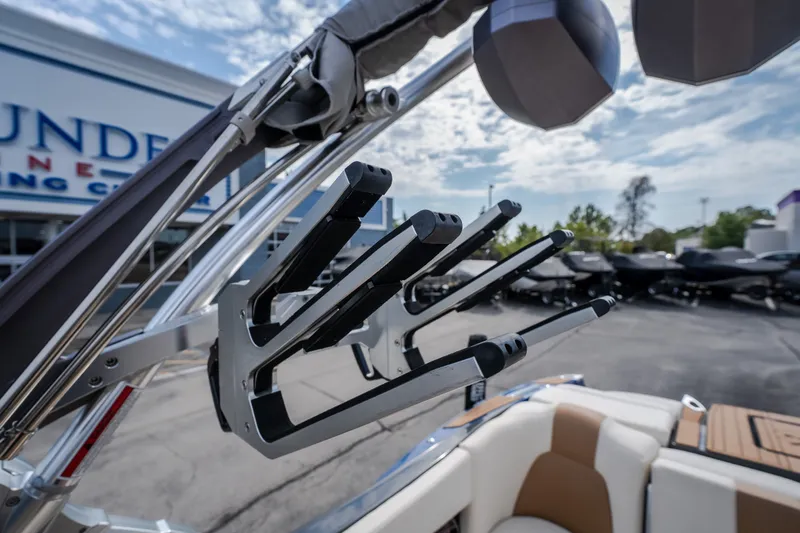 Slide: The Image of 2021 MasterCraft X24 boat with wakeboard rack, outdoor dealership setting. - 28