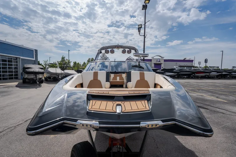 Slide: The Image of 2021 MasterCraft X24 boat displayed outdoors under a partly cloudy sky. - 4