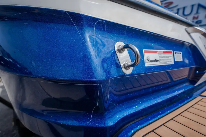 Slide: The Image of 2021 MasterCraft X24 boat with a sparkling blue finish and teak deck detail. - 14