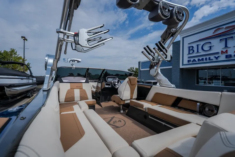 Slide: The Image of 2021 MasterCraft X24 boat interior with luxurious seating at a dealership. - 21