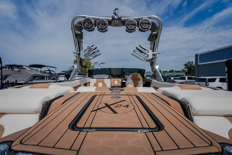 Slide: The Image of 2021 MasterCraft X24 boat with sleek design and advanced features, docked under a clear sky. - 16