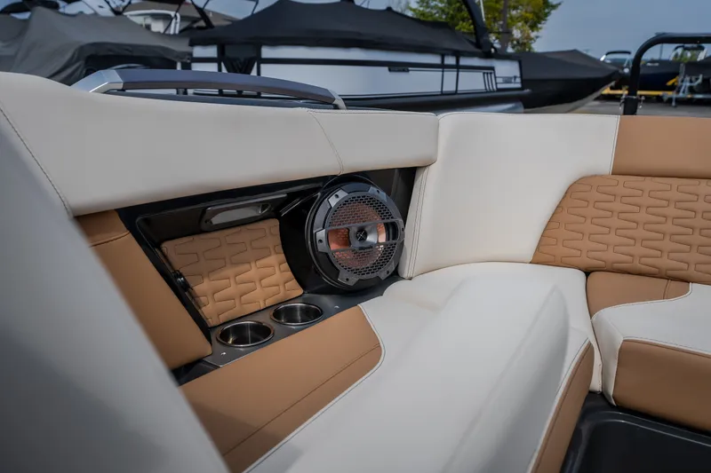 Slide: The Image of 2021 MasterCraft X24 boat interior with beige seating and built-in speaker system. - 38