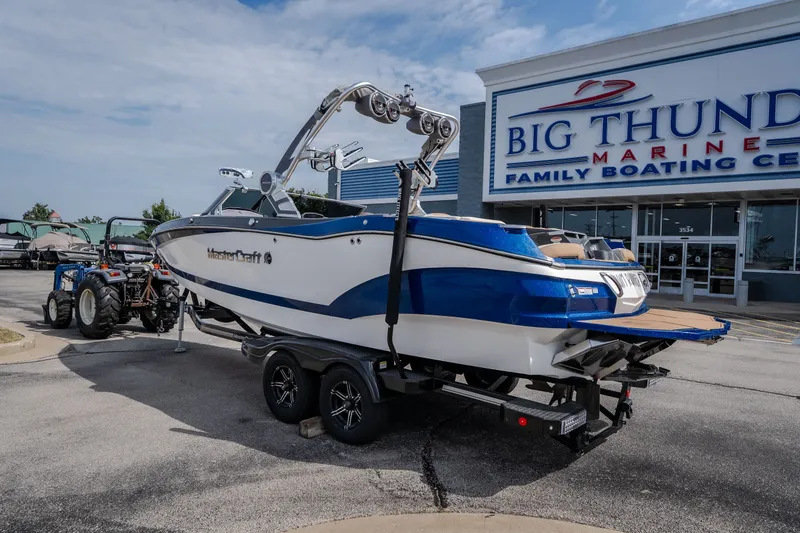 Slide: The Image of 2021 MasterCraft X24 boat on trailer at Big Thunder Marine dealership. - 13