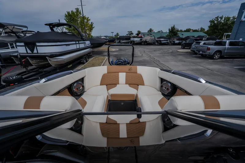Slide: The Image of 2021 MasterCraft X24 boat interior with luxurious seating in a marina setting. - 33