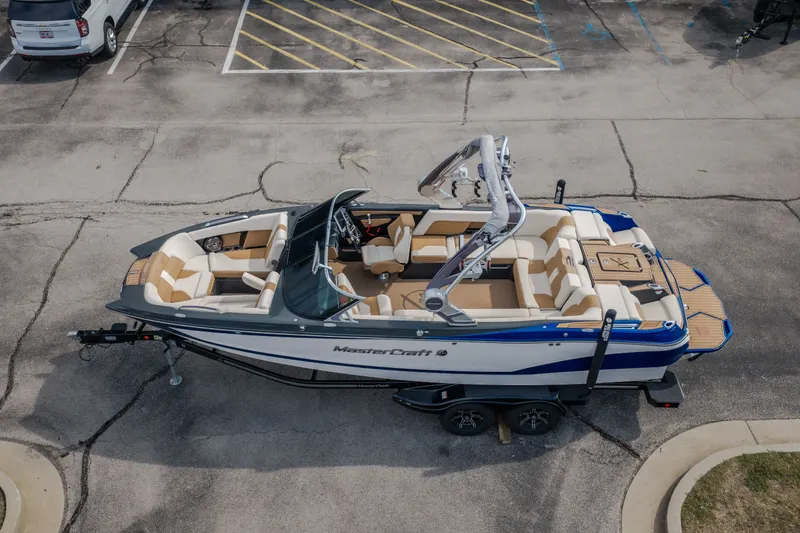 Slide: The Image of 2021 MasterCraft X24 boat on trailer in parking lot, aerial view. - 58