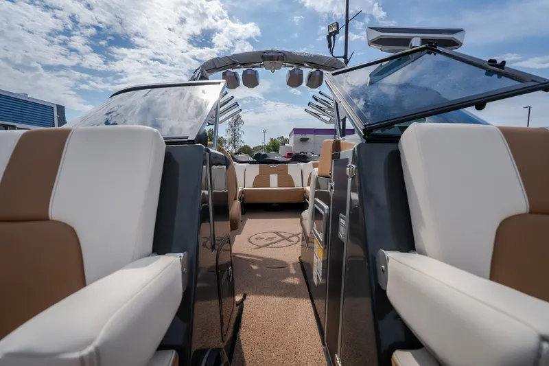 Slide: The Image of 2021 MasterCraft X24 boat interior with luxurious seating and open deck under a blue sky. - 39