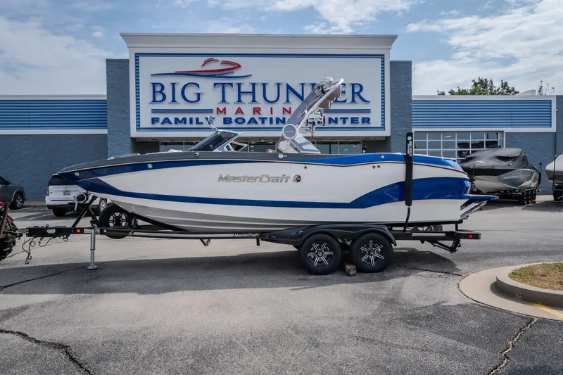 Slide: The Image of 2021 MasterCraft X24 boat on trailer at Big Thunder Marine dealership. - 1