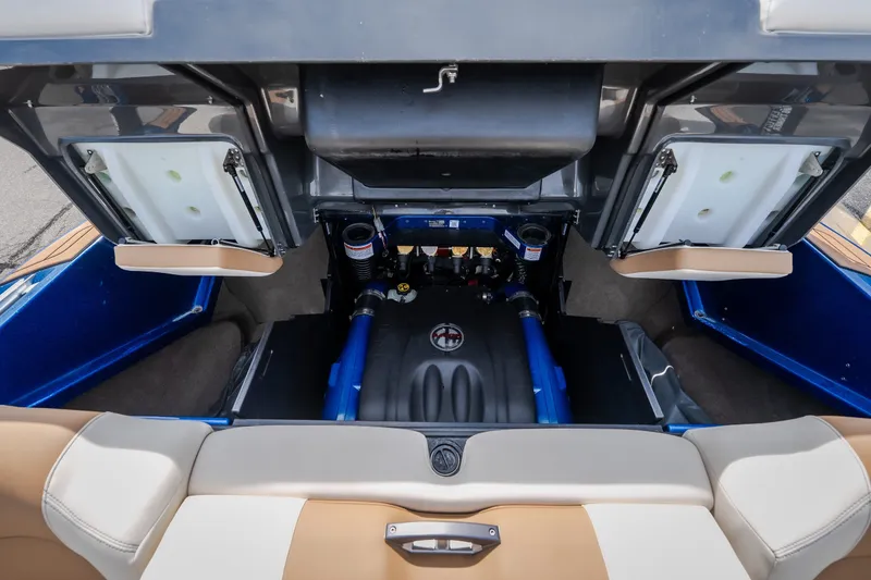 Slide: The Image of 2021 MasterCraft X24 boat engine compartment with open hatches, showcasing interior components. - 47