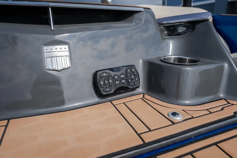 Slide: The Image of 2021 MasterCraft X24 boat dashboard with control panel and cup holder. - 15