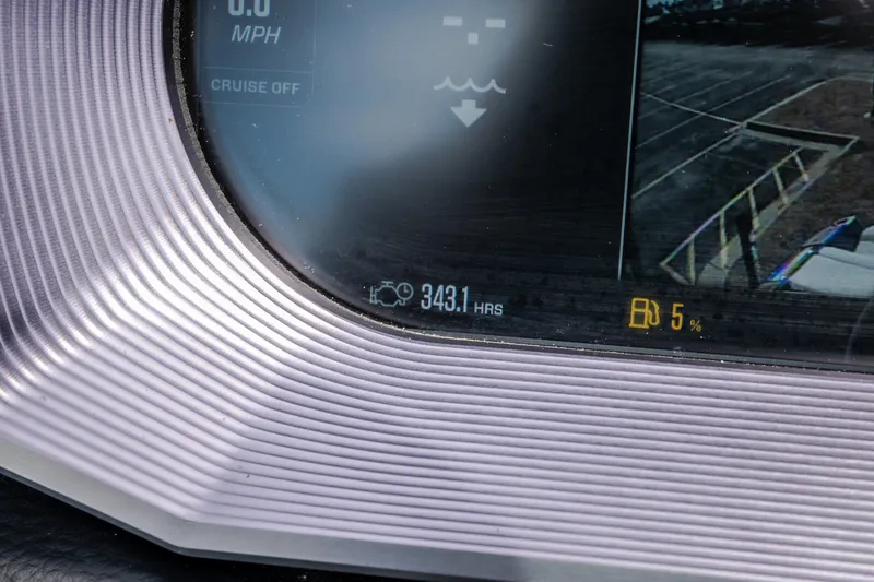 Slide: The Image of Close-up of 2021 MasterCraft X24 dashboard showing 343.1 hours and 5% fuel. - 24