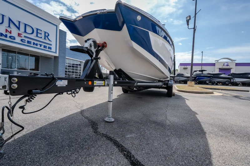Slide: The Image of 2021 MasterCraft X24 boat on trailer at dealership parking lot. - 53