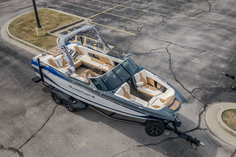Slide: The Image of 2021 MasterCraft X24 boat on trailer in parking lot, aerial view. - 56