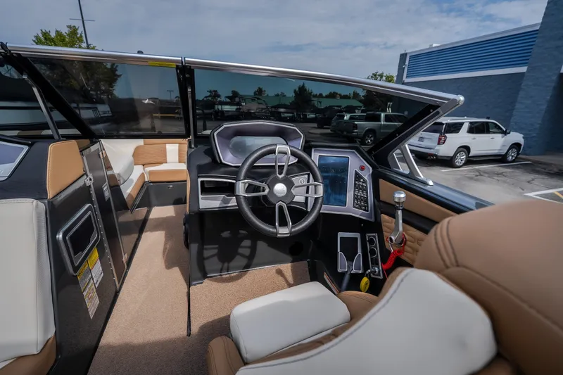 Slide: The Image of 2021 MasterCraft X24 boat interior with modern dashboard and steering wheel. - 25