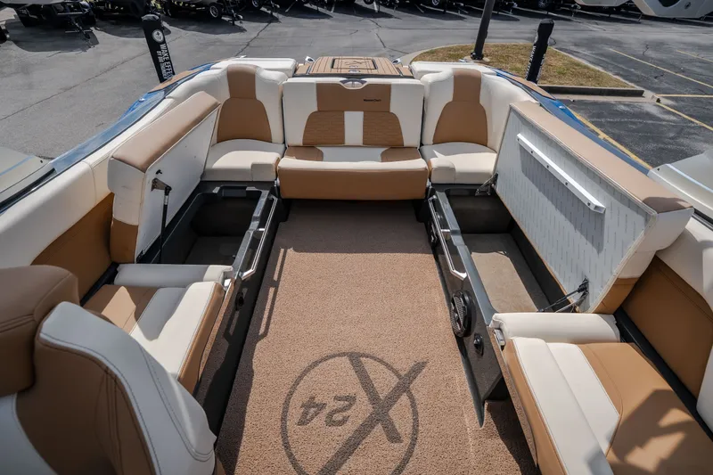 Slide: The Image of 2021 MasterCraft X24 boat interior with spacious seating and storage compartments. - 45