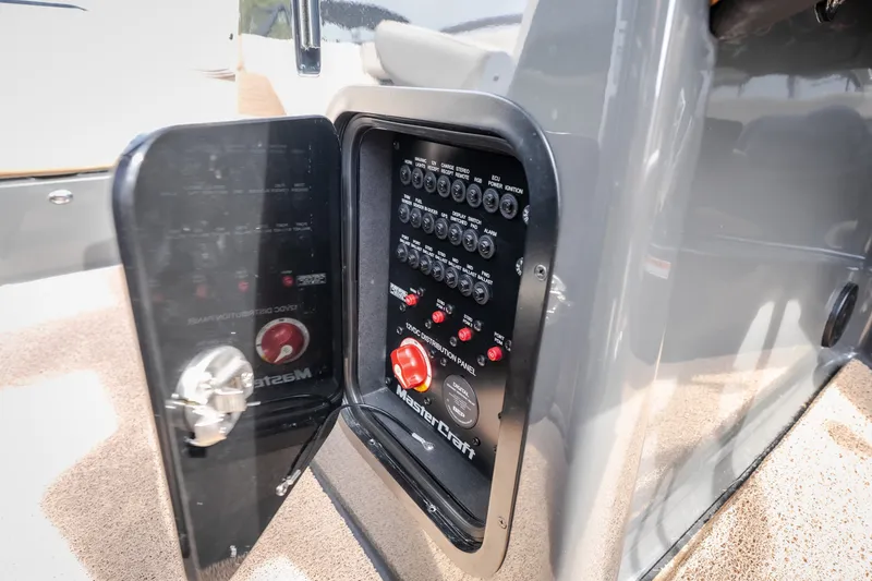 Slide: The Image of 2021 MasterCraft X24 electrical distribution panel with open access door. - 22
