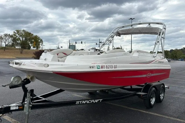 Slide: The Image of 2012 Starcraft 2000 IO Limited boat on trailer in parking lot. - 28