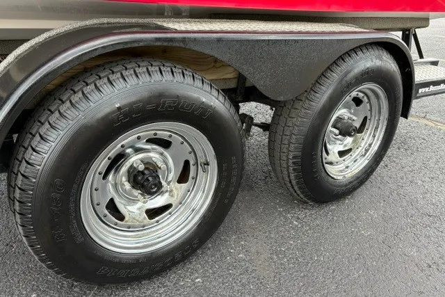 Slide: The Image of Trailer wheels of a 2012 Starcraft 2000 IO Limited boat on asphalt. - 38