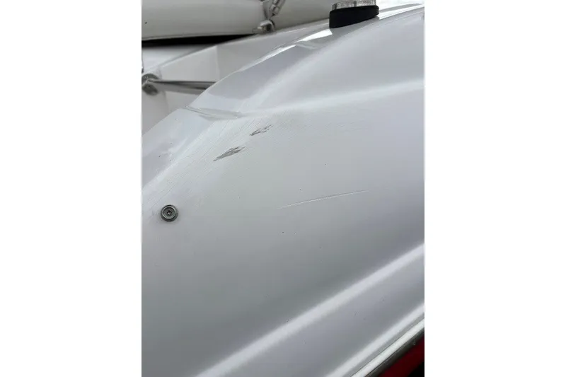 Slide: The Image of Close-up of a 2012 Starcraft 2000 IO Limited boat hull with visible scratches. - 14