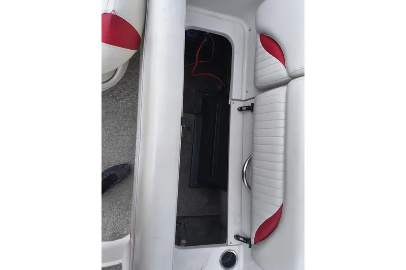 Slide: The Image of Interior storage compartment of 2012 Starcraft 2000 IO Limited boat with red and white seating. - 34