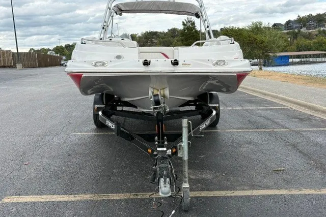 Slide: The Image of 2012 Starcraft 2000 IO Limited boat on trailer in parking lot near water. - 29