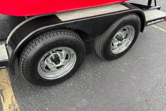 Slide: The Image of Trailer wheels of a 2012 Starcraft 2000 IO Limited on asphalt pavement. - 37