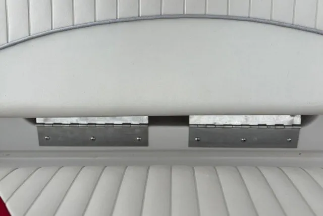 Slide: The Image of 2012 Starcraft 2000 IO Limited boat seat with white upholstery and metal hinges. - 15