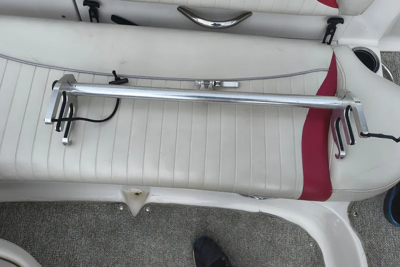Slide: The Image of Interior of a 2012 Starcraft 2000 IO Limited boat with a metal rod on white seats. - 35