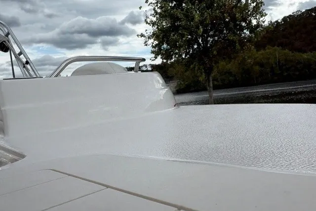 Slide: The Image of 2012 Starcraft 2000 IO Limited boat deck with scenic background and cloudy sky. - 36