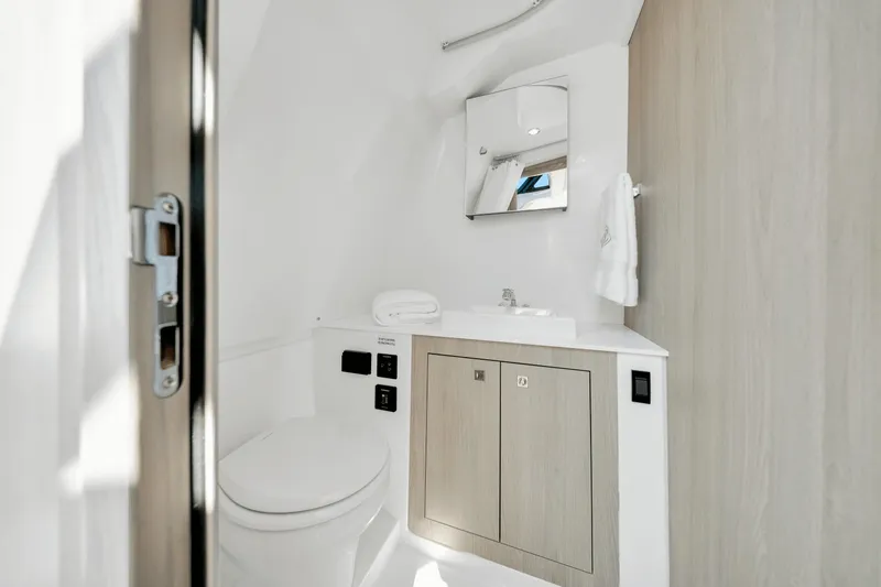 Slide: The Image of The image shows a modern yacht bathroom with a toilet, sink, and mirror. - 20