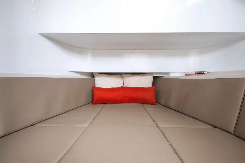Slide: The Image of Interior of a Cruisers Yachts 38 VTR with beige upholstery and a red pillow. - 24