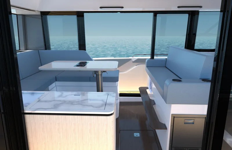 Slide: The Image of Interior of a modern yacht with blue seating and a table, surrounded by large windows overlooking the sea. - 12
