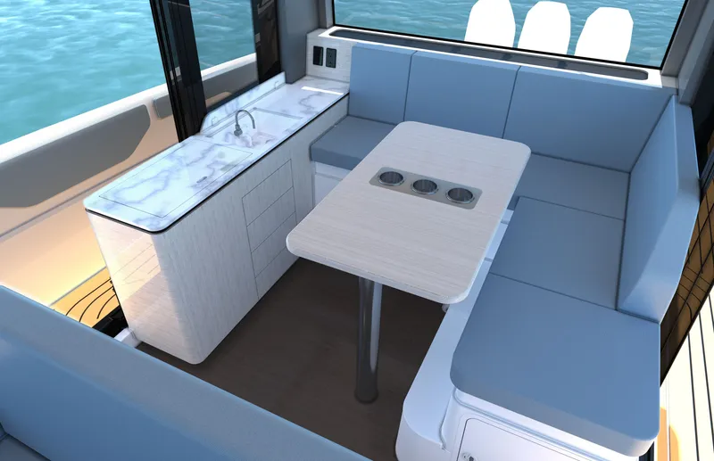 Slide: The Image of The interior view shows a modern seating area with a table and kitchenette. - 17