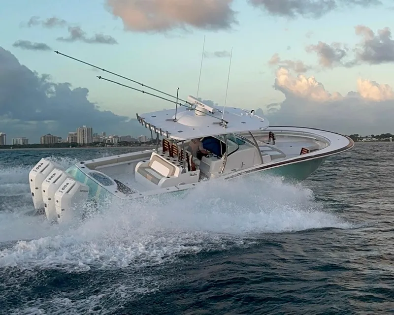 Slide: The Image of 2025 Mag Bay 38 CC boat cruising on open water at sunset. - 2