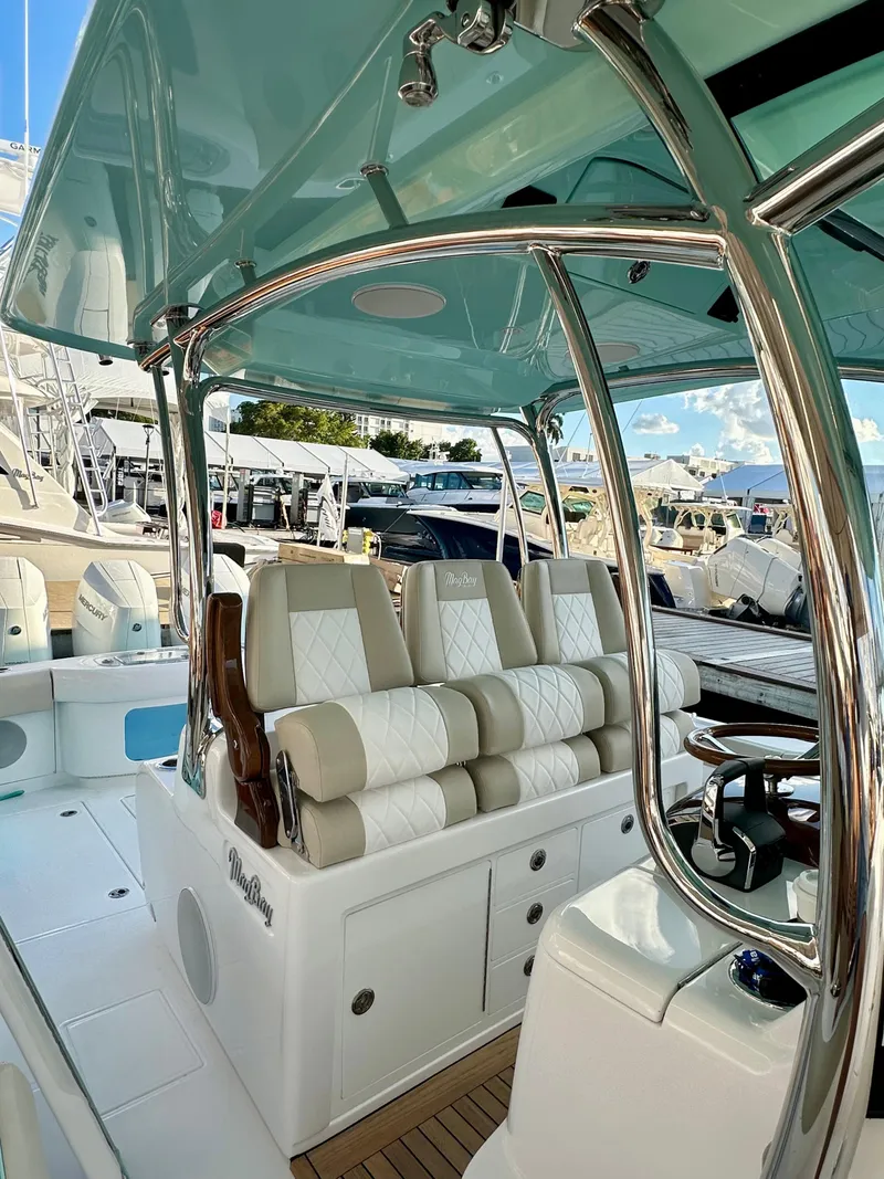 Slide: The Image of 2025 Mag Bay 38 CC boat with luxurious seating and sleek design. - 11