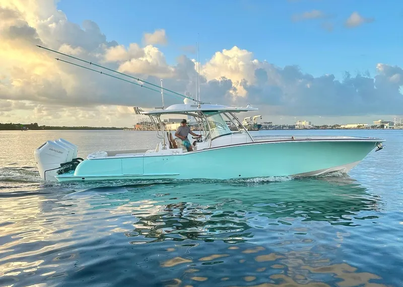 The Image of 2025 Mag Bay 38 CC boat cruising on calm water at sunset. - 0