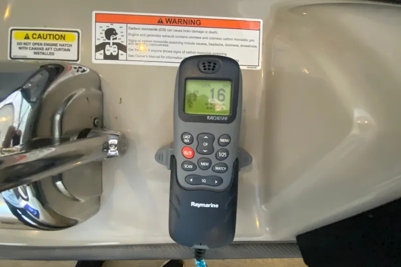 Slide: The Image of VHF radio on 2006 Sea Ray 38 Sundancer with safety warnings visible. - 18