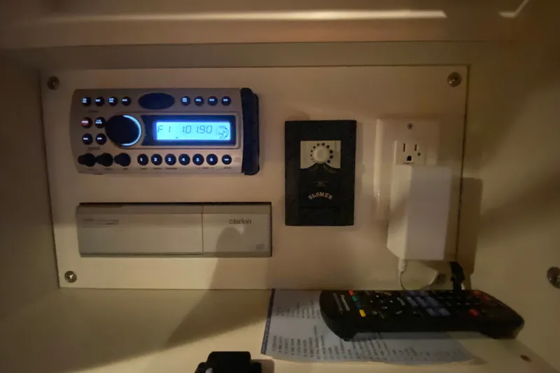 Slide: The Image of Control panel inside a 2006 Sea Ray 38 Sundancer yacht, featuring a Clarion stereo system. - 29